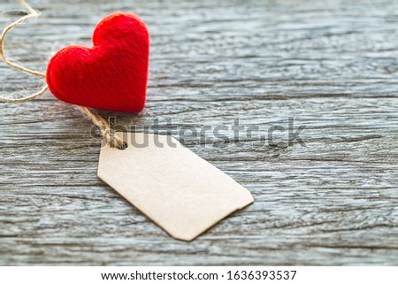 red heart shape with blank paper tag on wooden table background ,Image for Happy valentine day concept.