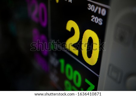 Vital signs data of patient on black screen.
