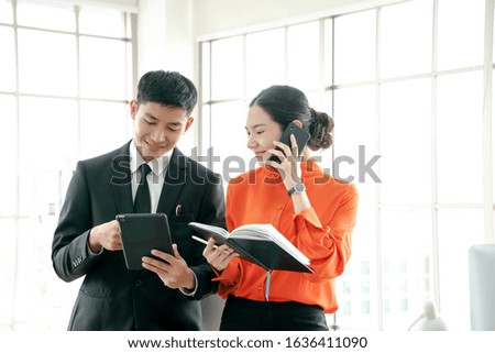 Business colleagues explain to client on mobile phone using digital tablet for results