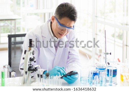 Asian Thai virologists are smiling after receiving good news from their Chinese friends that they can invent a vaccine and a drug used to treat pneumonia from a new strain of coronary virus 2019 Royalty-Free Stock Photo #1636418632