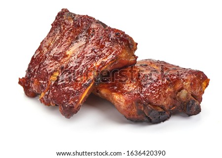 Delicious spicy marinated ribs in a bbq or tomato sauce, isolated on white background. Royalty-Free Stock Photo #1636420390