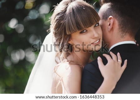 
beautiful portrait of young wedding couple. Beautiful bride looks into the camera. Wedding photography outdoors.