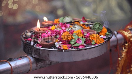 Traditional Indian worship with flowers, Diyas and leaves.