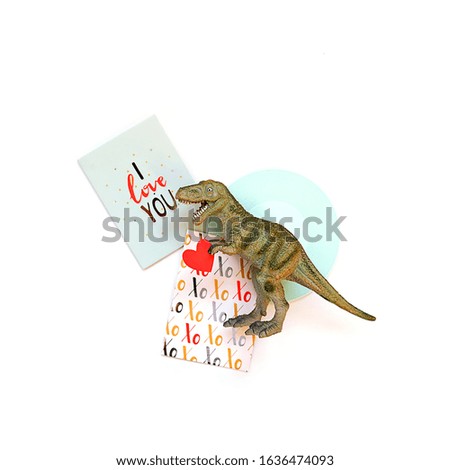 Dinosaur with heart and love card on white background. Valentine's day funny minimal creative concept. copy space