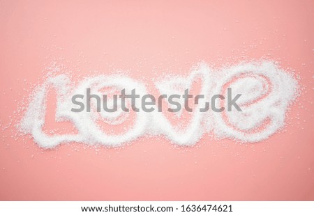 lettering with sugar on a pink background.