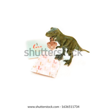 Dinosaur with jewelry heart on white background. Valentine's day funny creative minimal concept. copy space