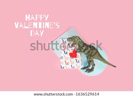 Happy Valentine's day greetings card. Dinosaur with red heart on pink background. funny minimal creative concept. 