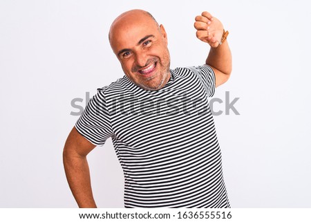 Middle age handsome man wearing striped navy t-shirt over isolated white background stretching back, tired and relaxed, sleepy and yawning for early morning