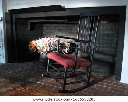 An interior photo of a house built in 1735 showing the large fireplace that was once the place for cooking. The swing arm for the iron pot was still there. 