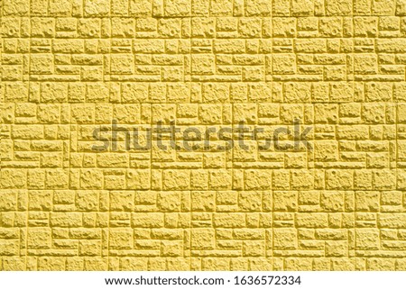 texture of yellow decorative brick in the form of tiles on the wall