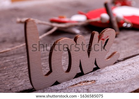 Word "Love" and Valentines Day gifts boxes on rustic old wooden background. Valentines Day concept background.