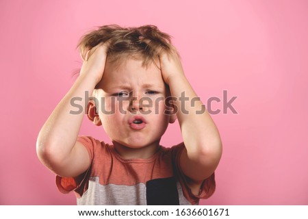 Portrait of child boy with hands on head.  
 Royalty-Free Stock Photo #1636601671