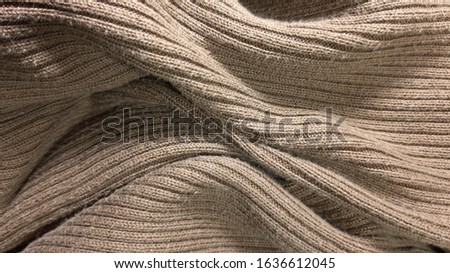 Knitted brown surface, texture. Modern abstract pattern. Photo material yarn, background 