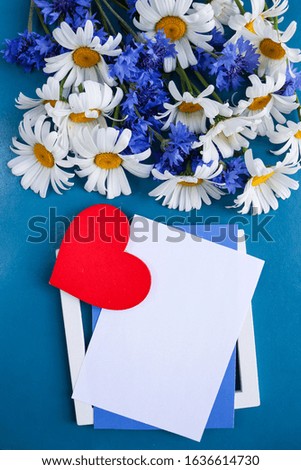 Valentine's background. red heart, flowers and an envelope. symbols of valentines day