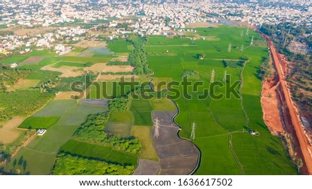 aerial view drone shot cityscape Madurai tamilnadu india green fields agricultural land railway line 