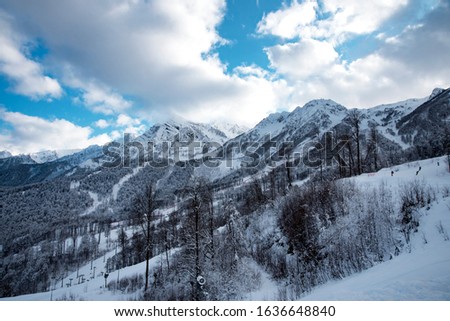 Winter mountain ski resort Rosa Khutor in Sochi.  Winter sunny day with cloudy in the Caucasus mountains.