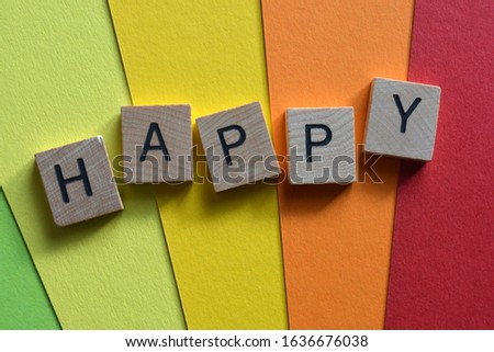 Happy, word in 3d wood alphabet letters a multicoloured background