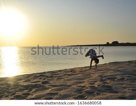 Cute girl has fun at sunset. Summertime concept.