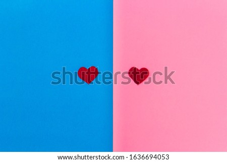 Two red felt hearts lie on a two-tone pink-blue background. Minimalism. Breakfast - Tea for Valentine's Day, Mother's Day. Holiday concept. Place for text.