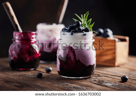 Sweet healthy yogurt with blueberry on the wooden table, rustic stile