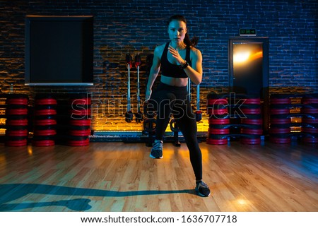 Shot of fit young woman doing jump aerobic exercises at gym. Aerobic and fitness exercises. Royalty-Free Stock Photo #1636707718