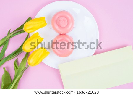 Top above high angle close up picture of beautiful cakes on plate with letter from lover isolated pastel color pink background