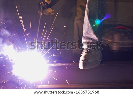 Welder working in his workshop. Welding metal