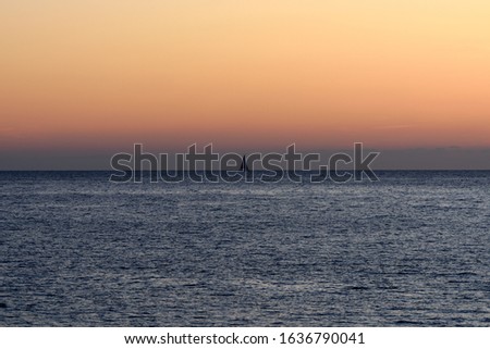 sailboat on the horizon during sunset