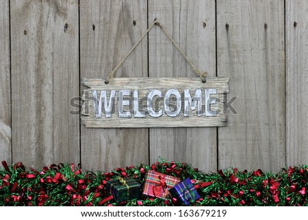 Wood welcome sign with red and green garland border