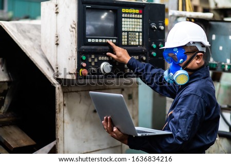 Officials from the Department of Hazardous substances control bureau is investigating the leak of a hazardous chemical in a chemical plant. Man with protective mask and computer laptops in factory Royalty-Free Stock Photo #1636834216