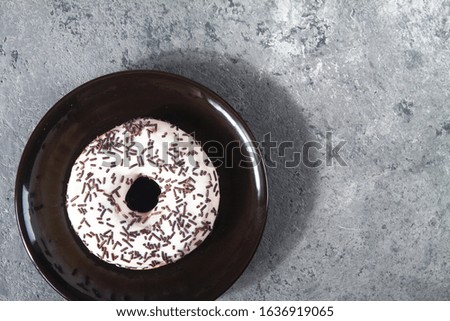 Baked sweet delicious donuts with pastry crumb on gray concrete background. Happy Donut Day.  National Donut Day Poster. American delicacy food. Space for text