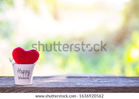 Valentine decorative with red heart  knitting shape in white bucket on wooden mock up over blurred green garden on day noon light,Image for happy valentine day concept.
