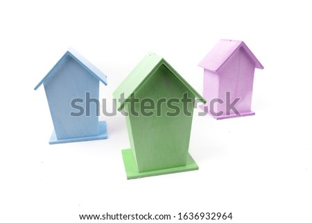rear view of a row of pastel colored bird houses isolated on white