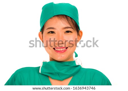 isolated portrait of young beautiful and happy Asian Korean medicine doctor woman or hospital nurse in medical hat and scrub smiling cheerful and positive in health care and physician job success