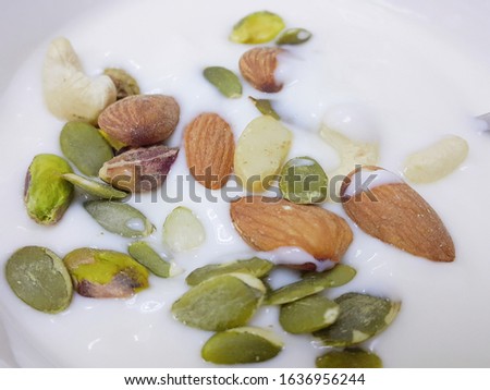 Mixed nuts (Almond, pumpkin kemels, cashew nuts, pistachio kemels, walnuts) topping on fresh yogurt.