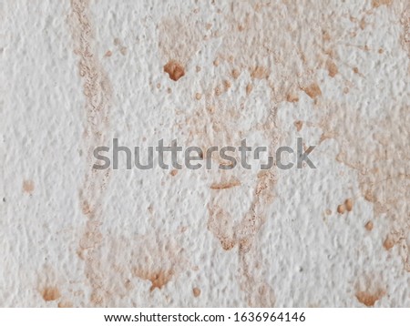 Brown cocoa spills on white walls