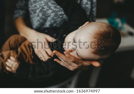 Beautiful baby son resting on mom's hand. Closeup portrait