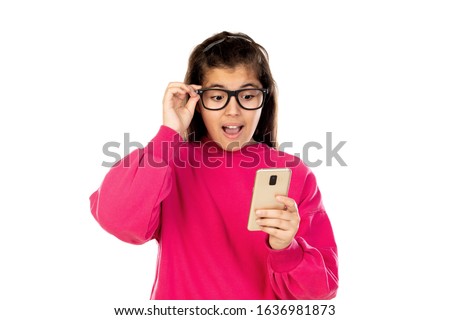 Adorable young girl with a mobile phone isolated on a white background