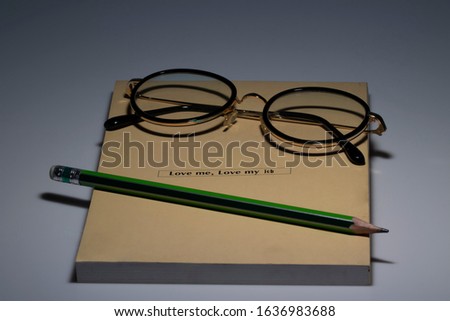 Glasses on book. Black eye glasses spectacles with shiny black frame For reading daily life To a person with visual impairment.