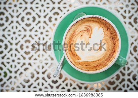 Green coffee cup on white table for relax time