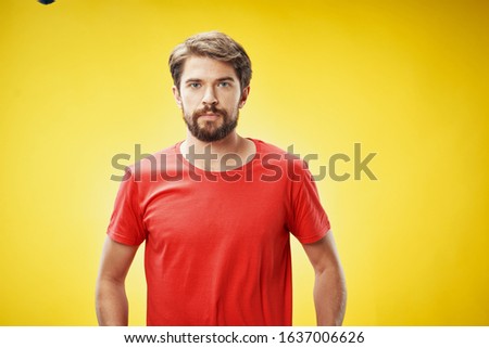 Red shirt yellow background young man emotions