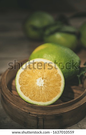 Beautiful color of green orange, on the  wooden table indoor