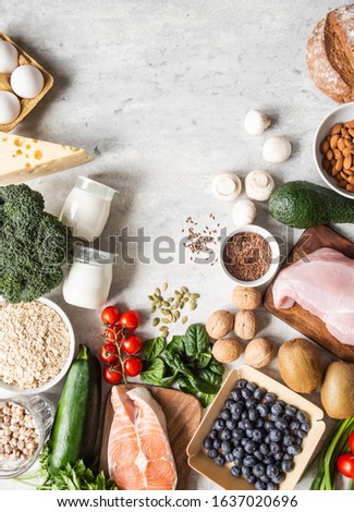 Healthy balanced ingredients frame. Flat lay of fruits, vegetables, dairy products, cereals, legumes, dietary meat and fish, nuts and seeds on the table. Top view. Balanced healthy food concept