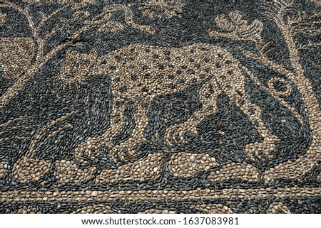 Mosaic of small pebbles depicting a cheetah and a rooster, a Park in the Palazzo Reale, Genoa, Italy.