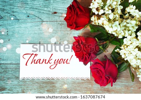 Red roses on wooden background. Greeting card. Thank you concept