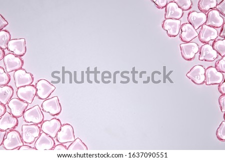 Background from small pink transparent hearts. Love heart frame. Happy mother's day concept. Love symbol. Holiday card background, copy space for text.