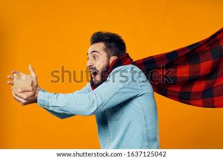 male young guy holds a hot drink