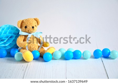 First birthday boy background with teddy bear , blue small balls and honeycomb ball , party decoration