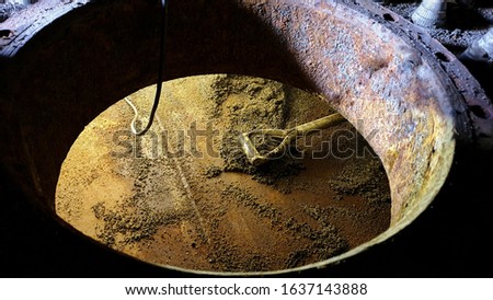 Confined space entry for cleaning job. Spade and lighting inside narrow confined space of tank.  Royalty-Free Stock Photo #1637143888