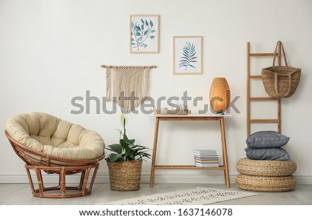 Living room interior design with comfortable papasan chair and wooden table Royalty-Free Stock Photo #1637146078